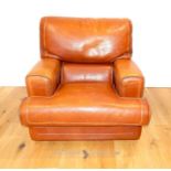 A designer type tan leather armchair