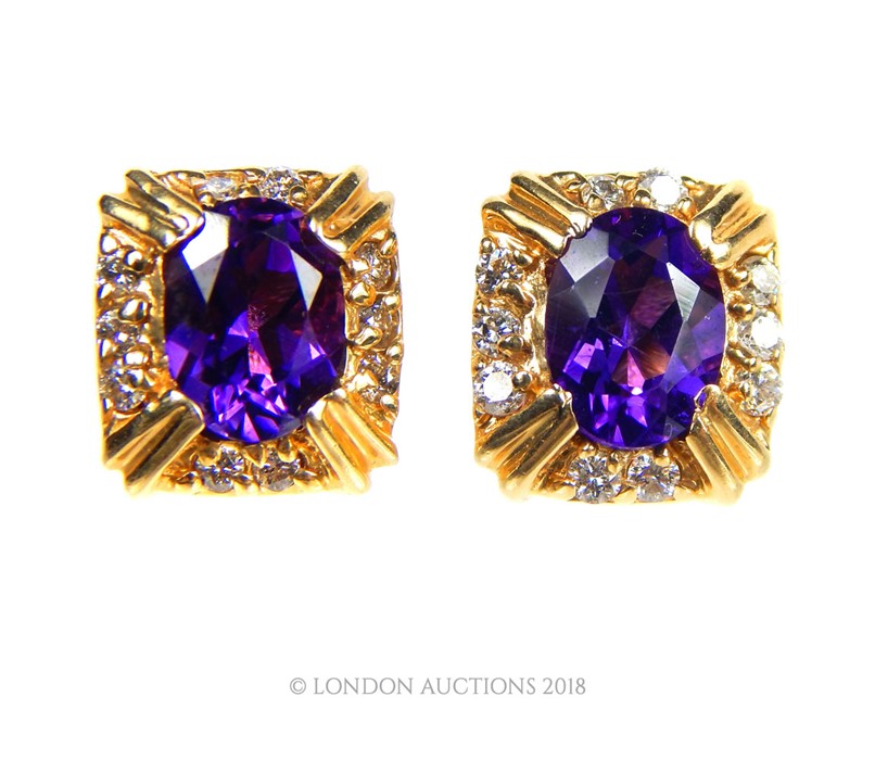 A pair of 14 carat Yellow Gold Amethyst and Diamond earrings.