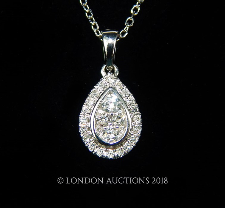 An 18 carat white Gold Diamond pendant necklace on Gold chain.