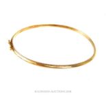 A 9 carat yellow gold bangle