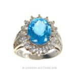 A Sterling Silver Dress Ring Set With A blue topaz white sapphire.