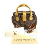 A Louis Vuitton small handbag.