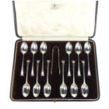 Antique set of twelve coffee spoons and sugar tongs.