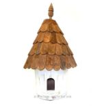A large cone shaped bird house.