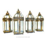 A set of four circular storm lanterns.