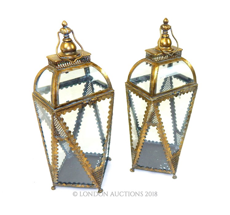 A pair of gilt storm lanterns.