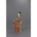 A CHINESE FAMILLE ROSE PORCELAIN FIGURE