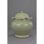 A LARGE CHINESE LONGQUAN CELADON JAR AND COVER