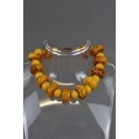 AN AMBER BEADED NECKLACE