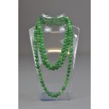 A CHINESE JADEITE BEADED NECKLACE