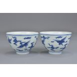 A pair of Chinese 20th century or earlier blue and white porcelain tea cups decorated with cranes am
