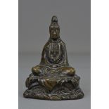 A Chinese 19th century bronze seated Guanyin. 12 cm tall.