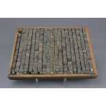 A Chinese early 20th century printing block with individually carved wooden character stamps. 24cm x
