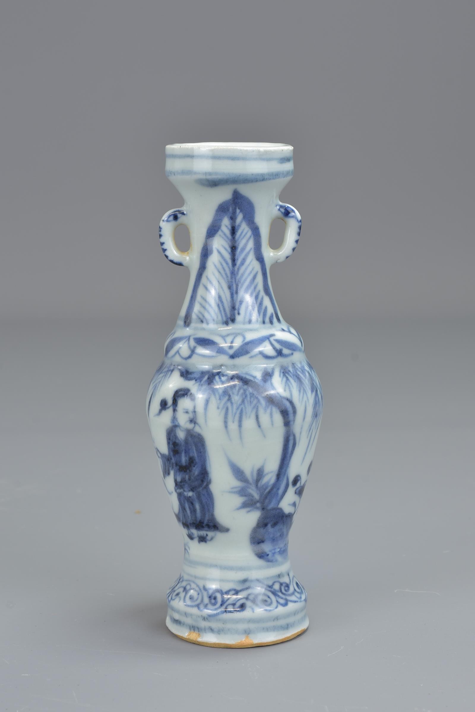 A Chinese 17th century Ming dynasty blue and white porcelain vase with twin handles decorated with f