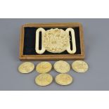 A fine 19/20th century Japanese carved ivory two piece belt buckle with a chrysanthemum design in a