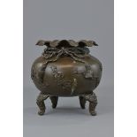 A Japanese 19th century Meiji period bronze censer. One leg missing. Makers mark to base. 23cm wide