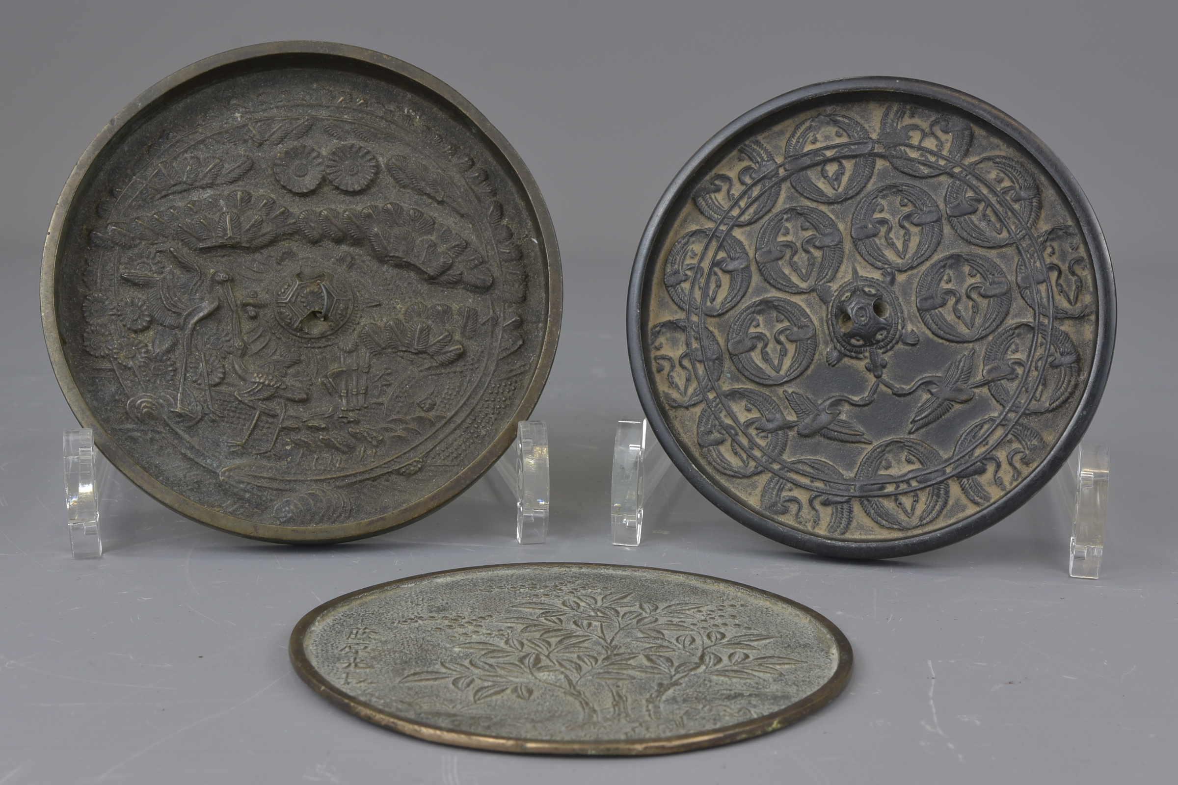 Three Japanese 18th century or earlier bronze mirrors. 10cm, 11cm and 12cm (3) Provenance: Held in p