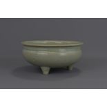 A Chinese Ming dynasty or later celadon porcelain tripod censer. 25cm diameter