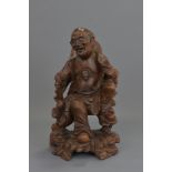 A Chinese 19th century carved wooden figure of an Immortal. 30 cm tall