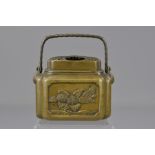 A Japanese 18th century bronze hand warmer with handle. 12cm (D)