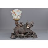 A 20th century Chinese carved hardwood lamp stand in the form of a boy on a cow. All on a separate c