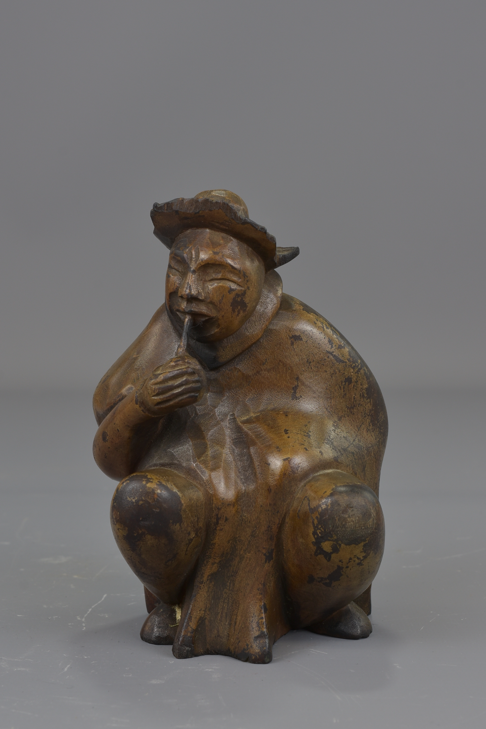A Japanese 19th century carved wooden seated figure. 14 cm tall.