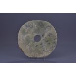 A large Chinese Neolithic or later jade disc head. 27.5cm diameter
