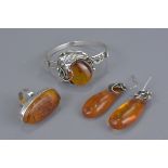 Four items of Amber and silver jewellery. Including one bracelet, a ring and a pair of earrings. (4)