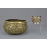 An Indian 19th century silver colour metal begging bowl together with a smaller lotus shaped bowl. 2