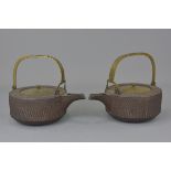 A pair of Japanese 18th century Edo period iron sake warmers. 19cm and 21 cm (damage to one handle).