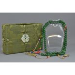 A Chinese 20th century green stone and rock crystal court jewellery necklace in a silk box.