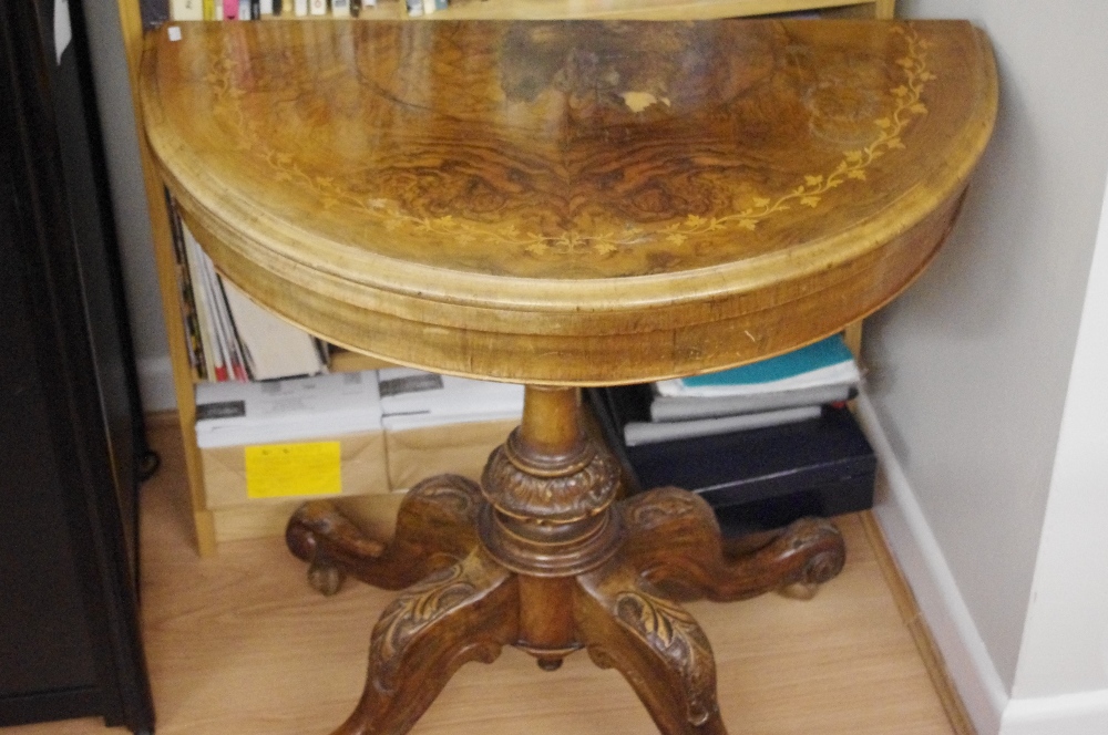 A Victorian inlaid walnut fold-over games table of D-form.