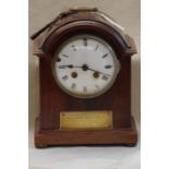 A wooden cased eight-day mantel clock.