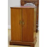 A floor standing coin collector's cabinet.