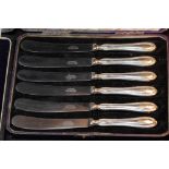 Two cased sets of six silver handled butter knives.