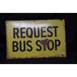 A Request Bus Stop enamel sign.