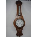A 1930s oak banjo barometer with thermometer.
