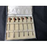 A cased set of six cocktail sticks.