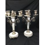 A pair of early 20th century marble and silver plated candle sticks.