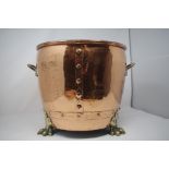 A copper and brass twin handled log bin.