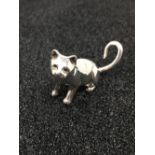 A cast silver figure of a seated cat.