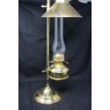 A brass oil lamp on stand.