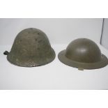 Two British military tin helmets.