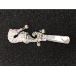 A silver baby's teething rattle.