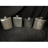 Four assorted hip flasks.