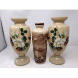 A pair of cream opaline vase with floral decoration and an opaline vase with moonlit lake scene.