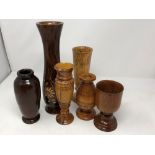 A box of assorted treen including goblets, vases, lidded pots, etc.