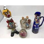 A box of assorted ceramics and glassware including paper weights and a Murano glass clown.