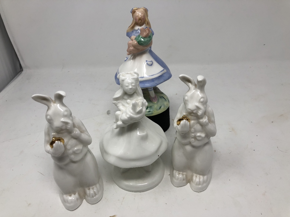 A collection of Alice in Wonderland ceramic figures.