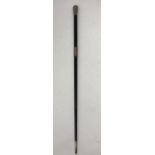 An ebonised conductor's baton with embossed silver handle.